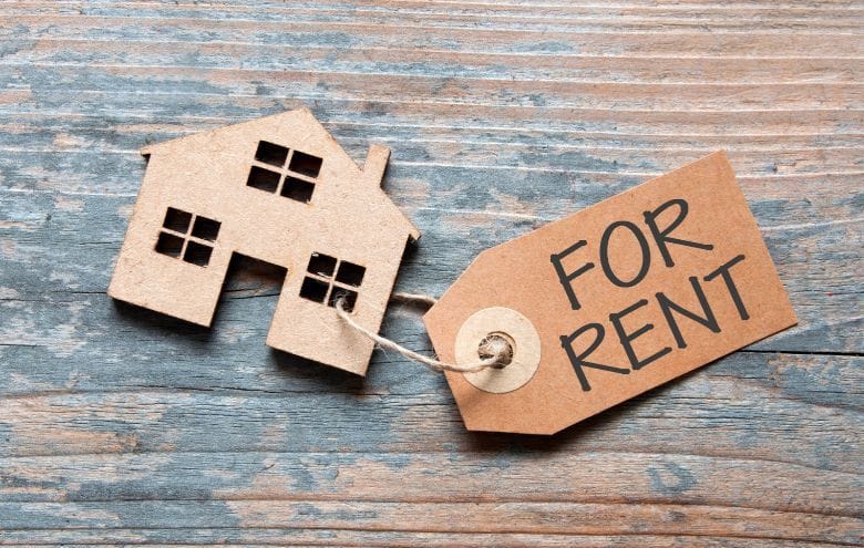 Cardboard house with "for rent" tag