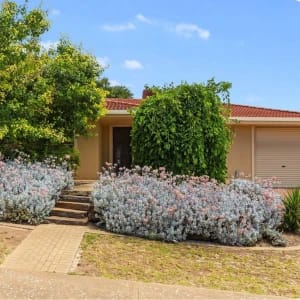 Suburban home with red tile roof, garage.
