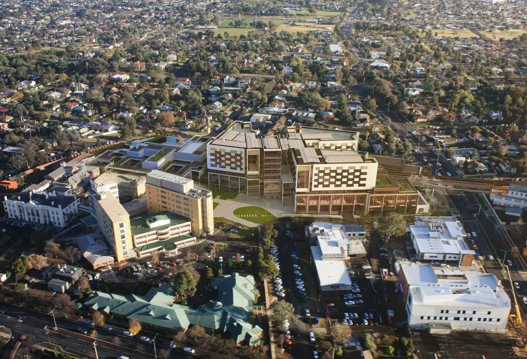 Aerial view of a hospital complex and surrounding neighborhood.