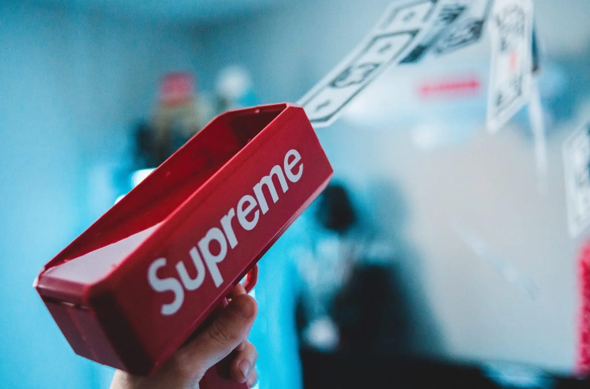 Red Supreme money gun shooting fake money