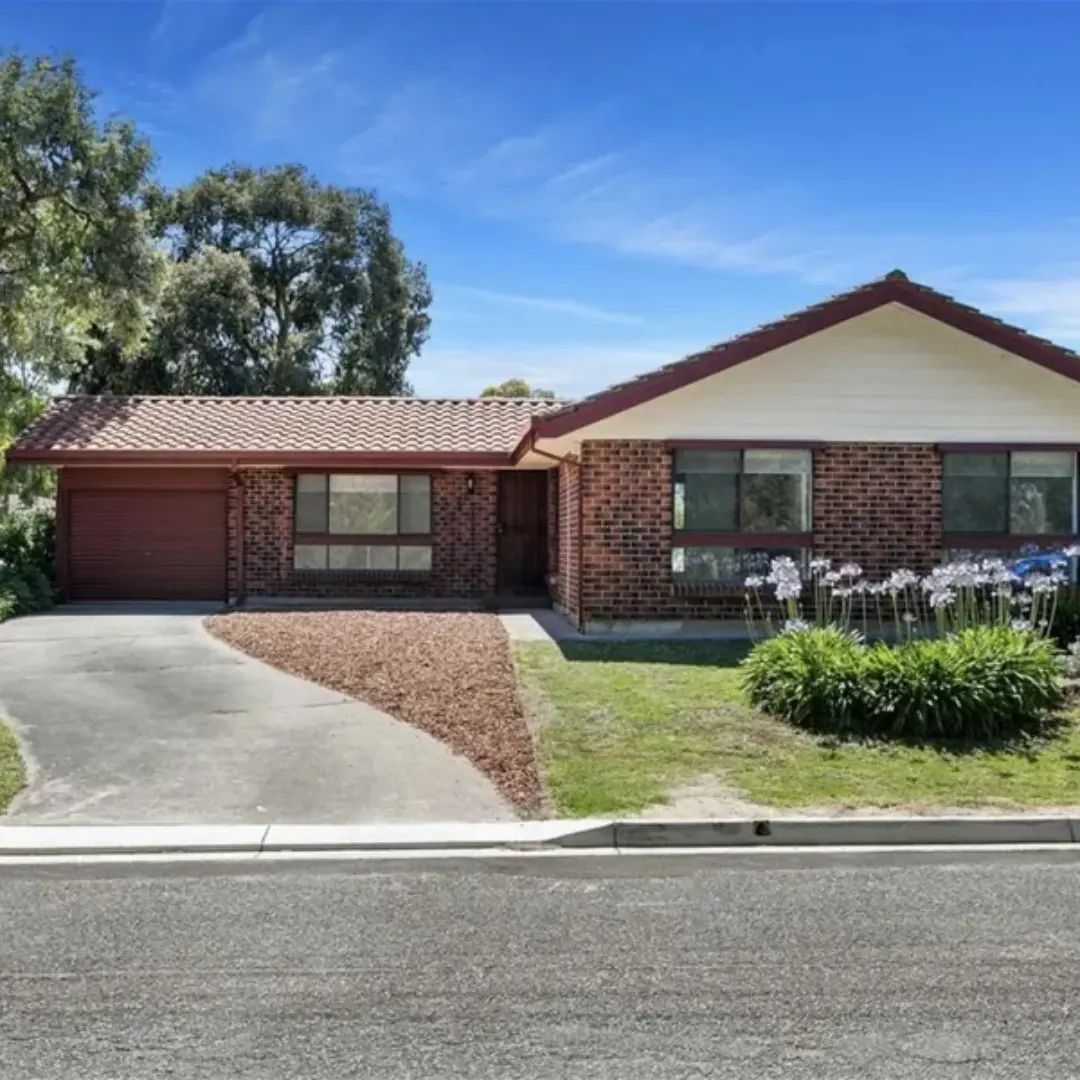 Brick house with garage and garden.
