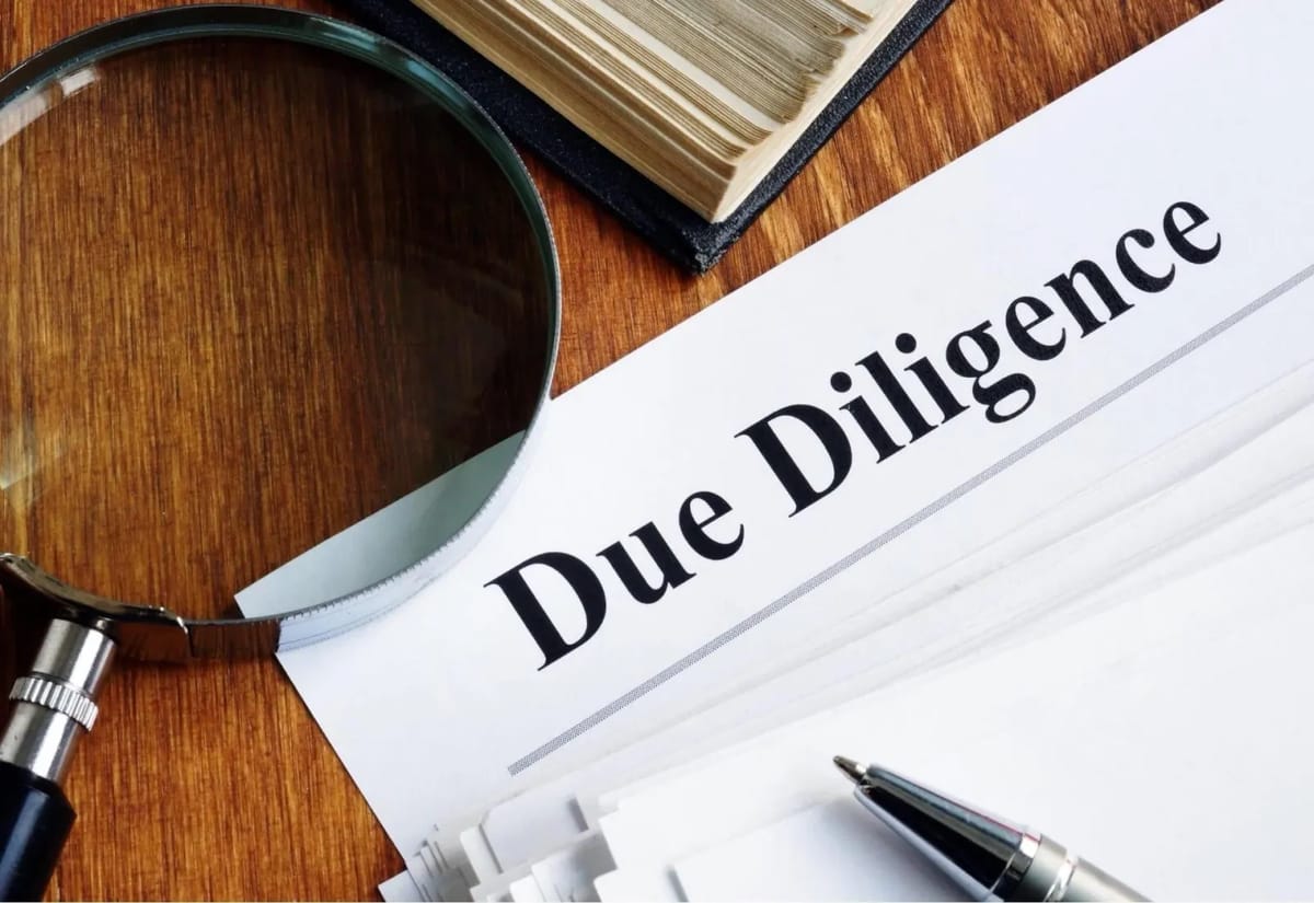 Due Diligence document with magnifying glass and pen