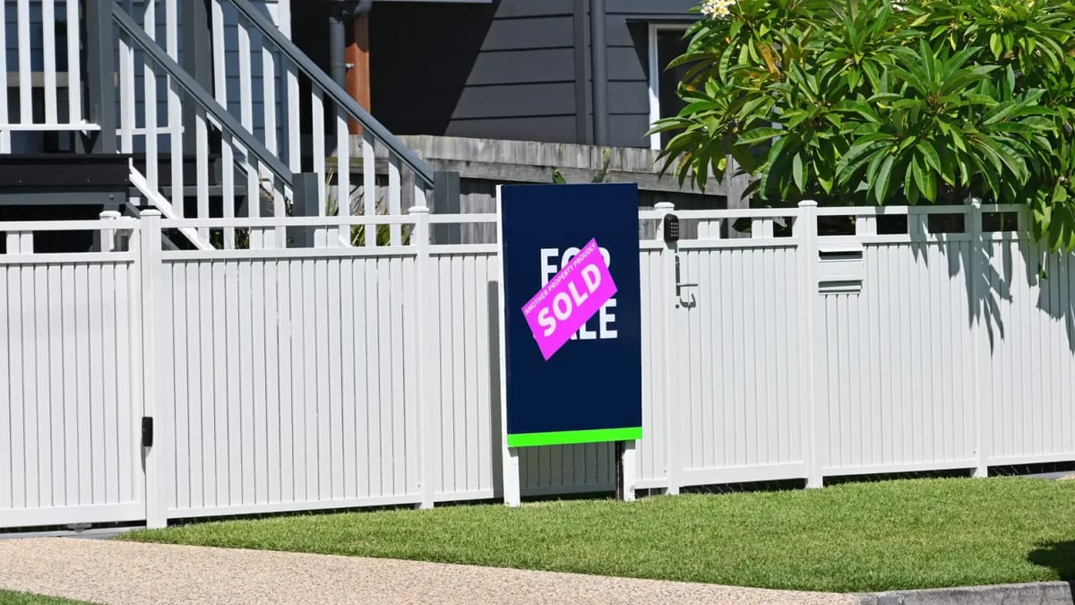 "For Sale" sign with "Sold" sticker