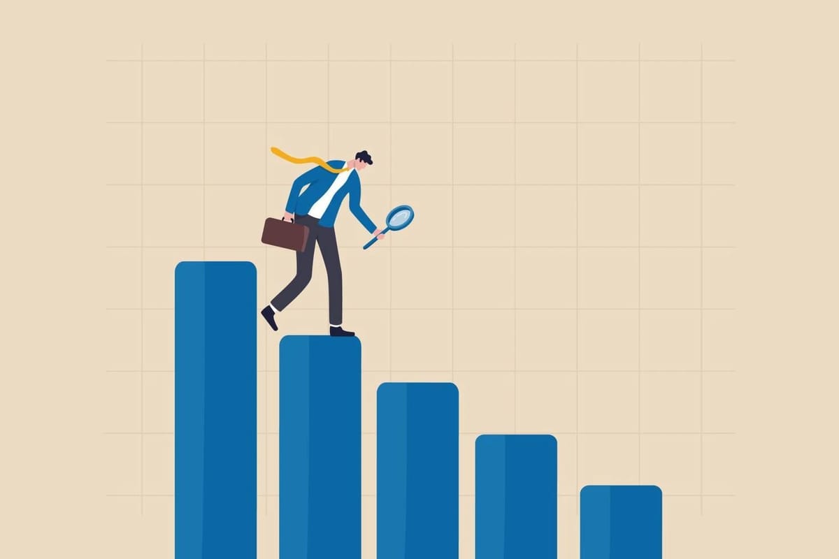 Man with briefcase and magnifying glass on declining bar graph