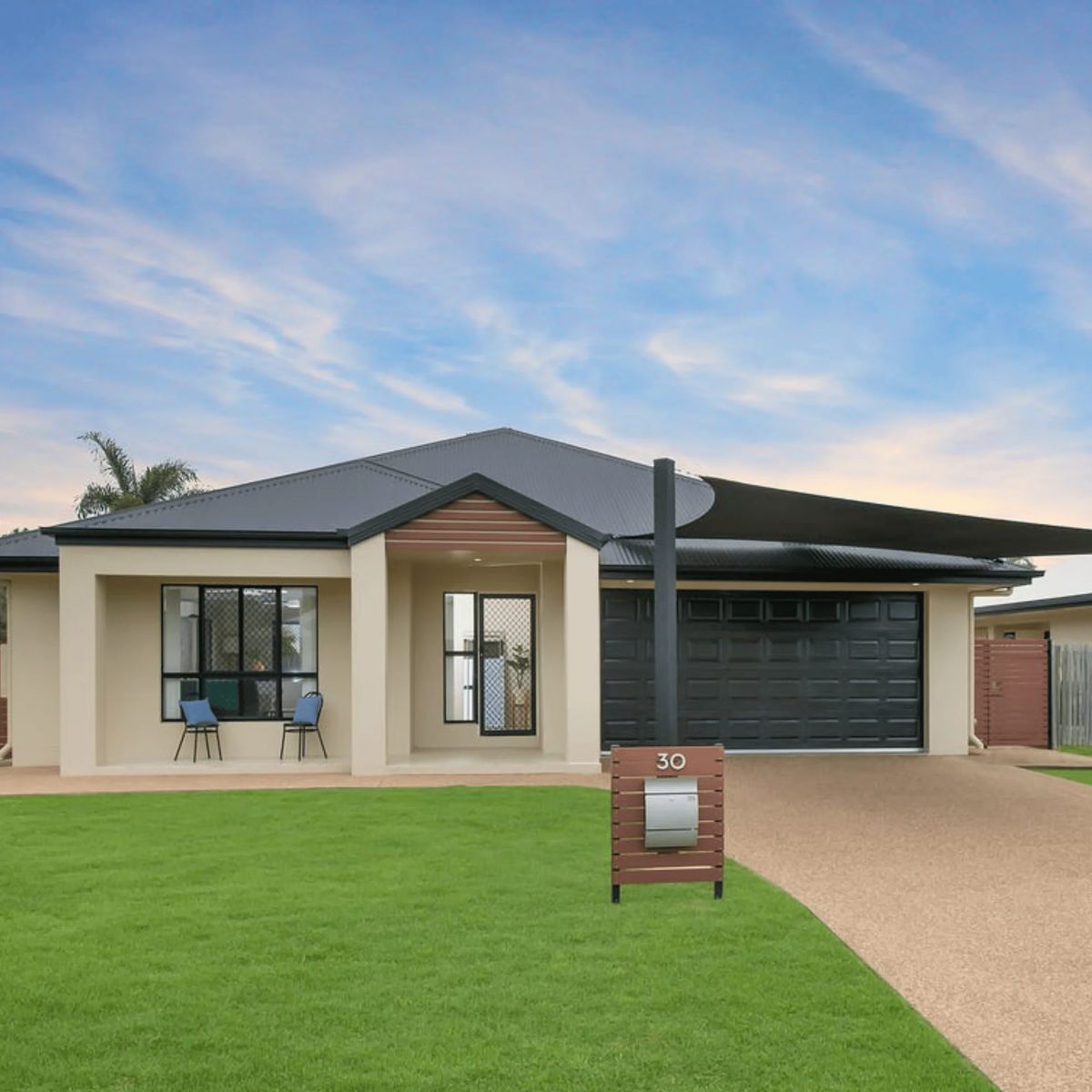 View of modern house with garage and mailbox.