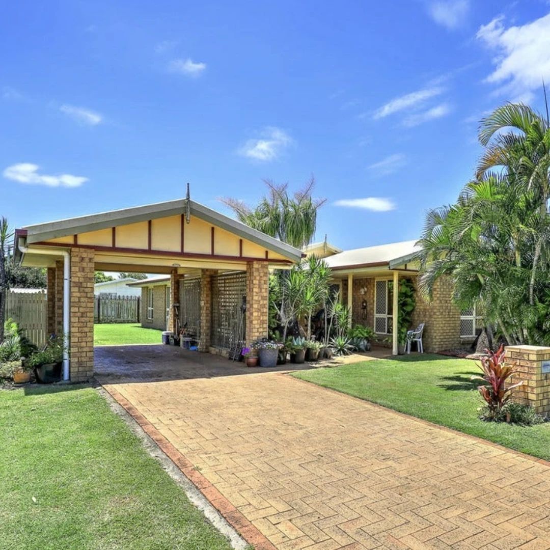 Brick house with carport and paved driveway