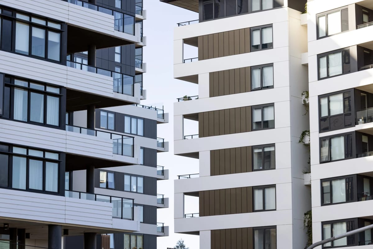 Modern apartment buildings with balconies and large windows.
