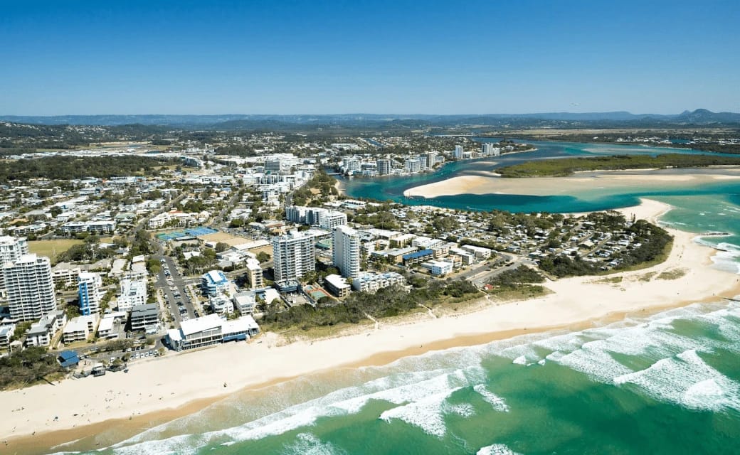Coastal town with beach, buildings, and river delta