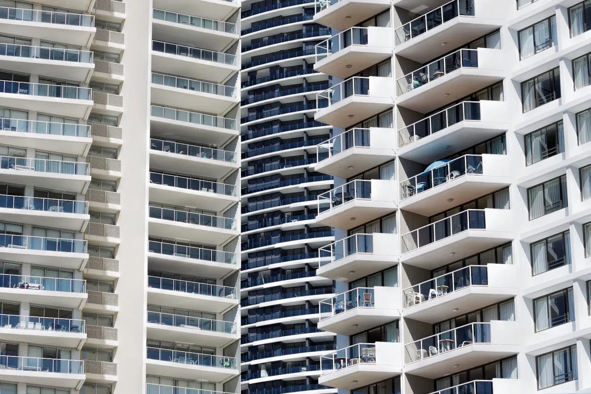 Apartment balconies stacked on a modern high-rise building.