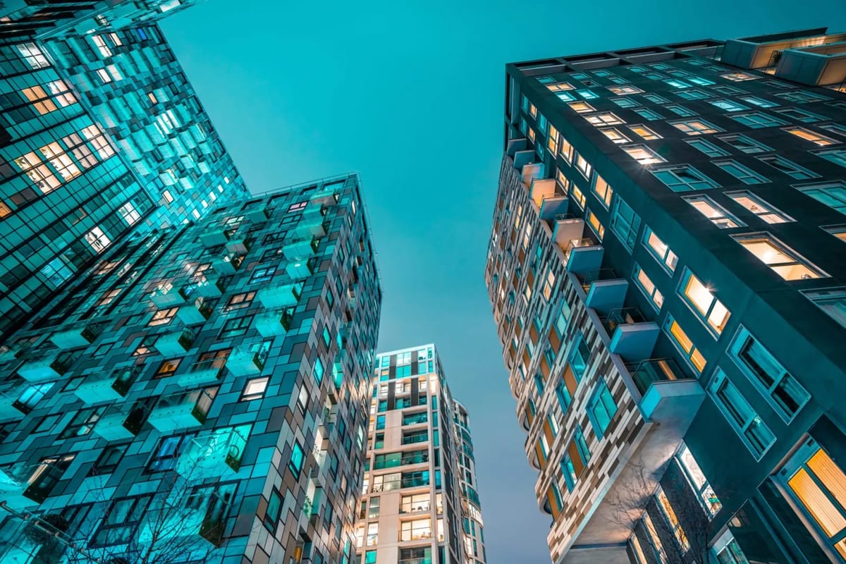 Apartment buildings at dusk with glowing windows