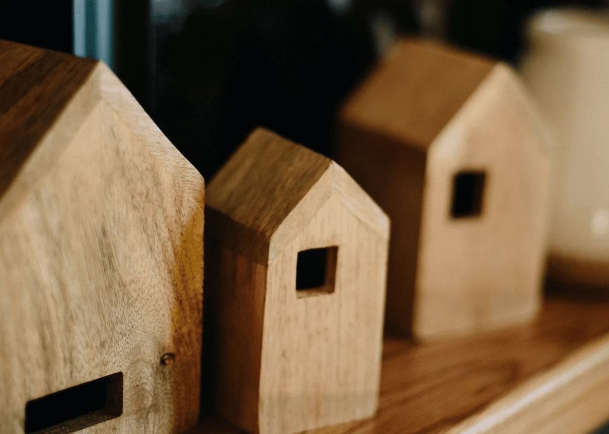 Wooden house figurines with cut-out windows.