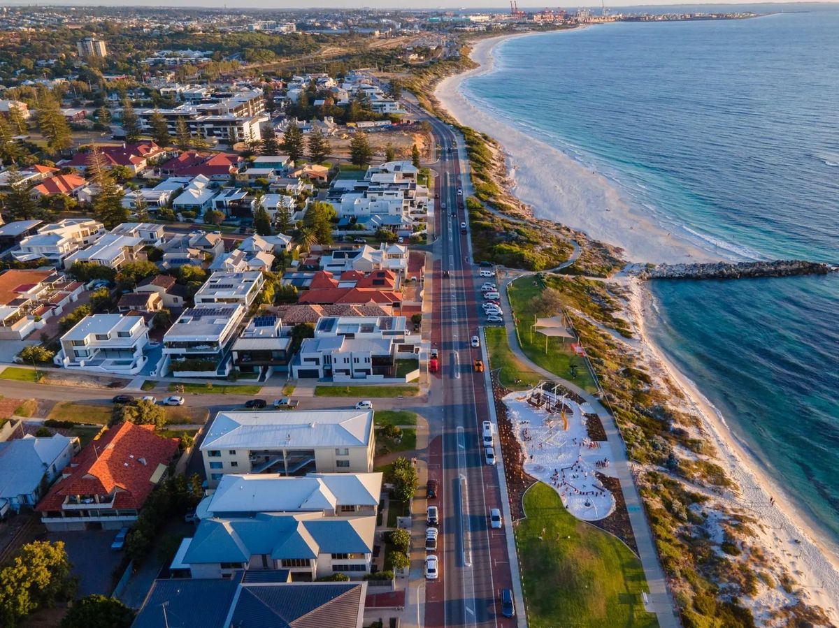 Coastal road with houses, beach, and playground