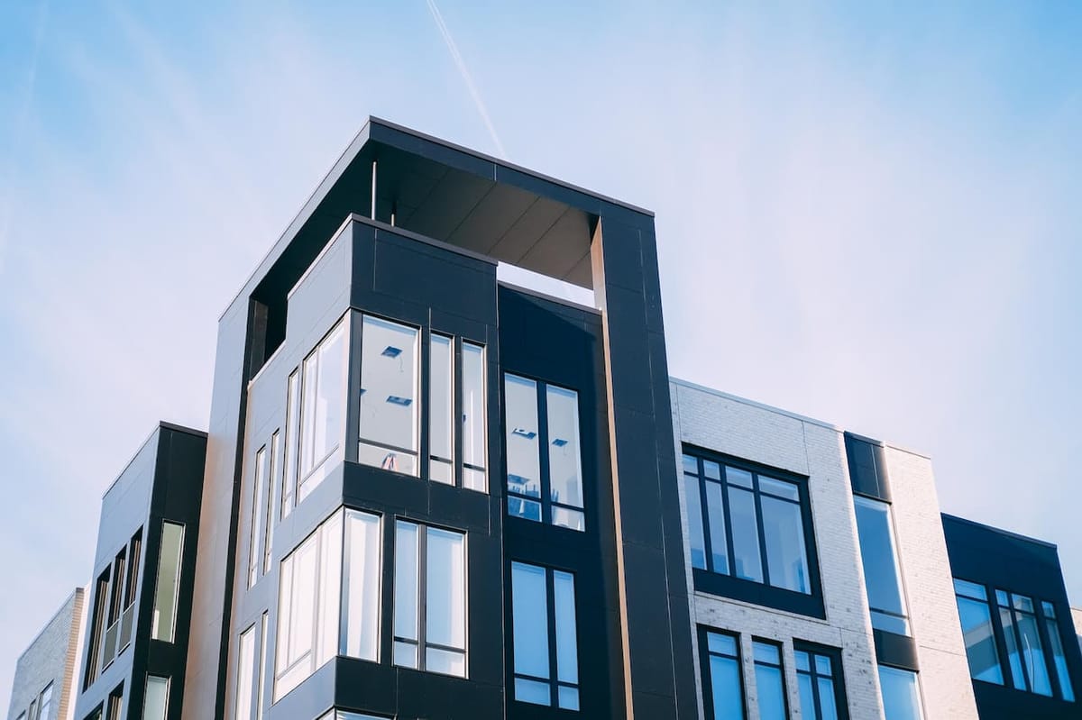 Modern building with large windows against sky.