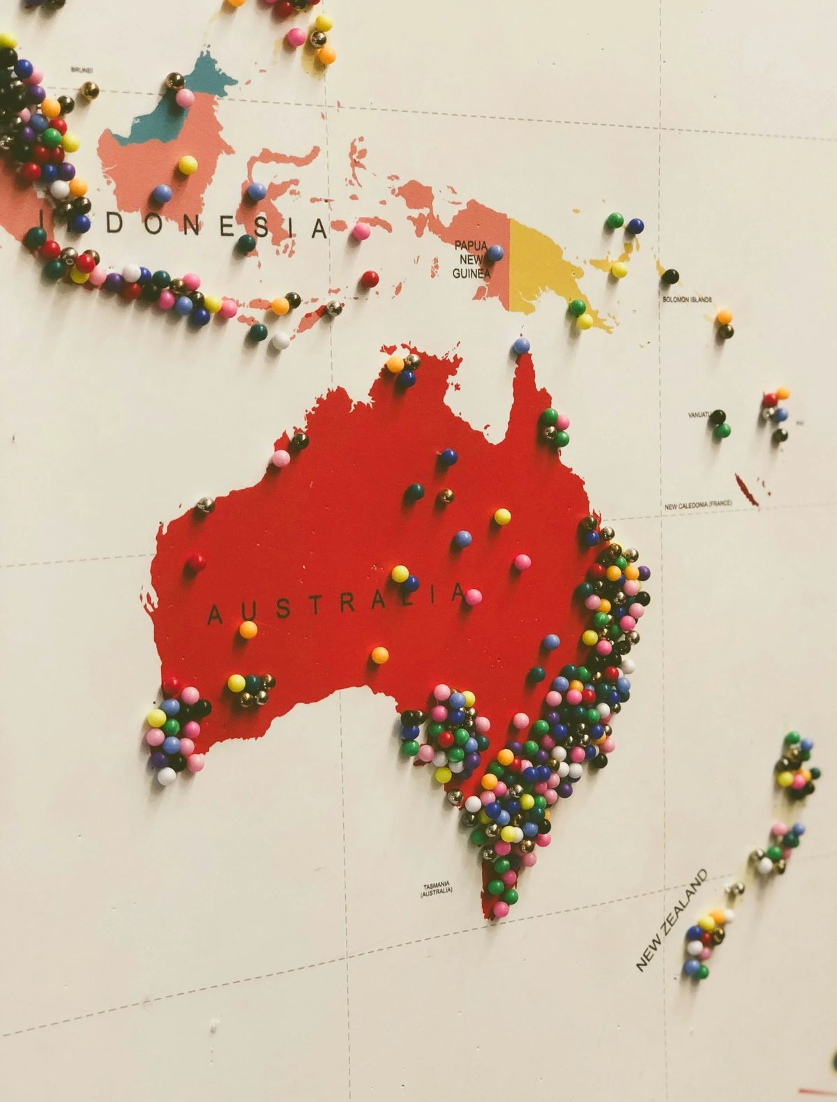 Map of Australia and islands with many colorful pins.