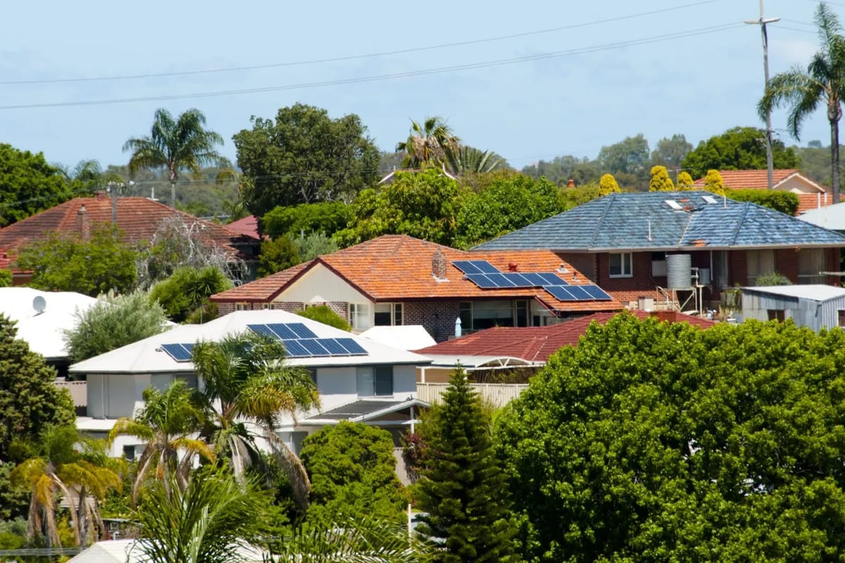 Suburban rooftops with solar panels.