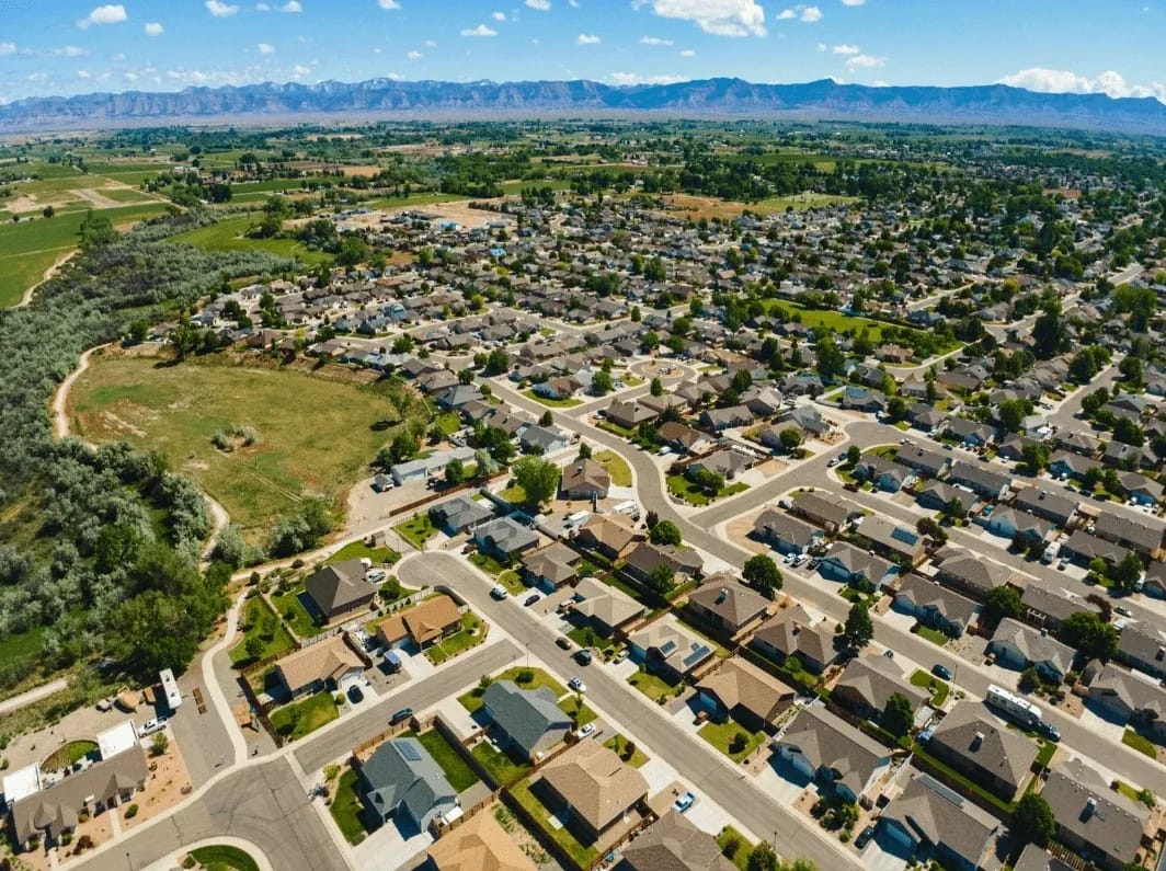 Aerial view of suburban homes with mountains in distance