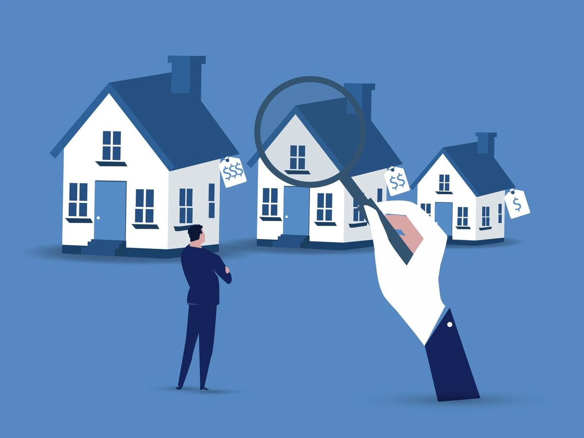 Man looking at houses with prices, magnifying glass over one