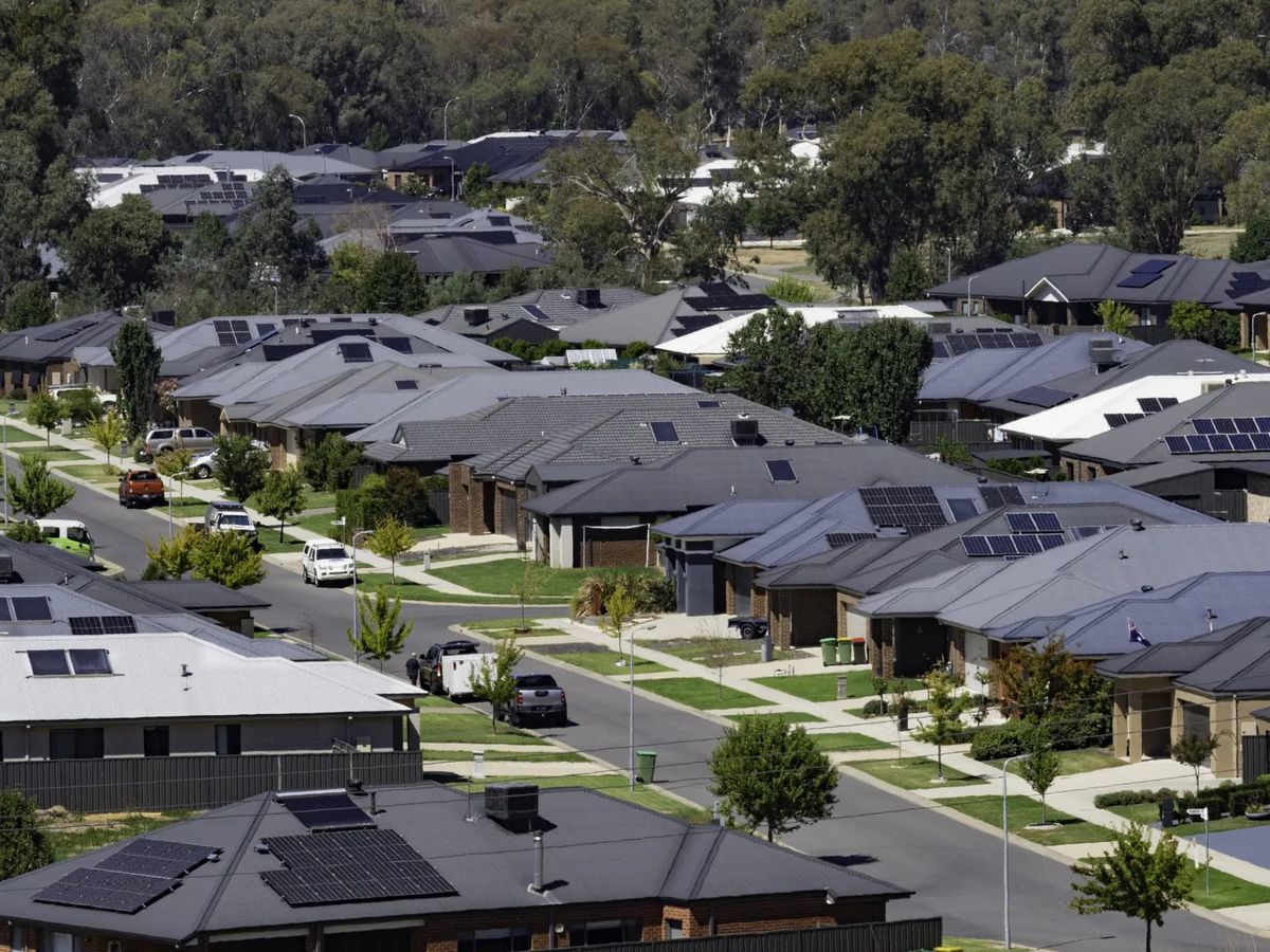 Neighborhood with many houses and solar panels visible.