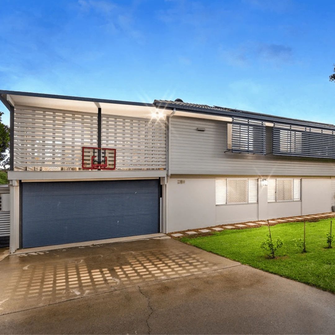 Modern house with basketball hoop and garage.