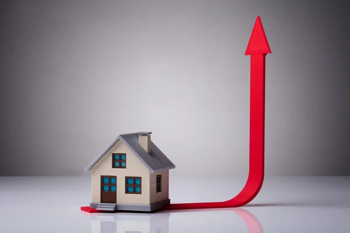 Model house with red arrow pointing up