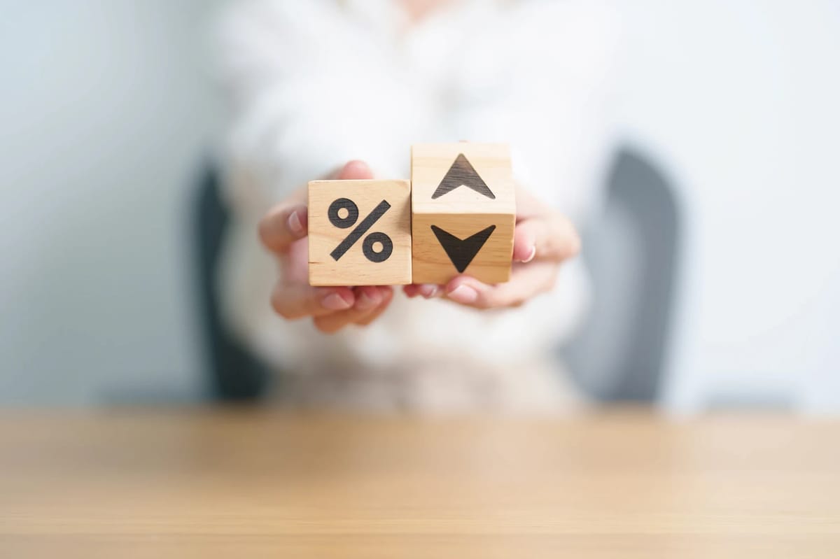 Wooden percentage blocks showing rising and falling interest rates