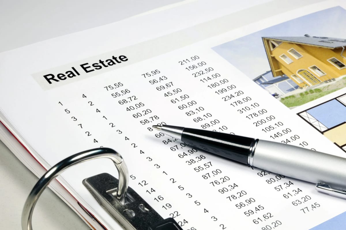 Real Estate document with numbers and pen, house image.