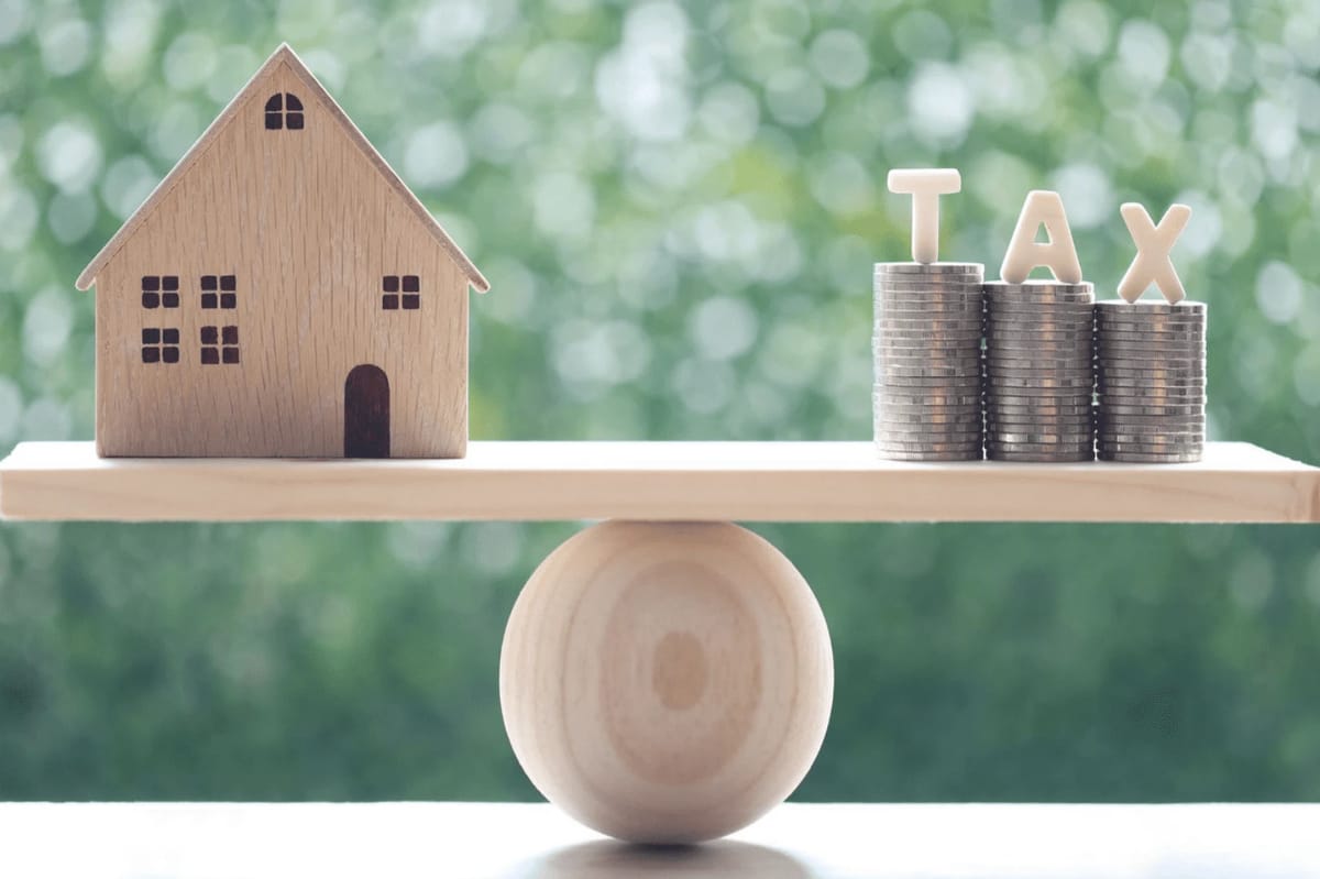 House and coins on a balance scale