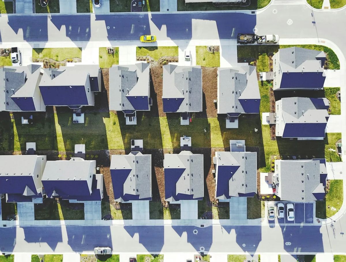 Aerial view of a planned housing estate with rows of detached homes