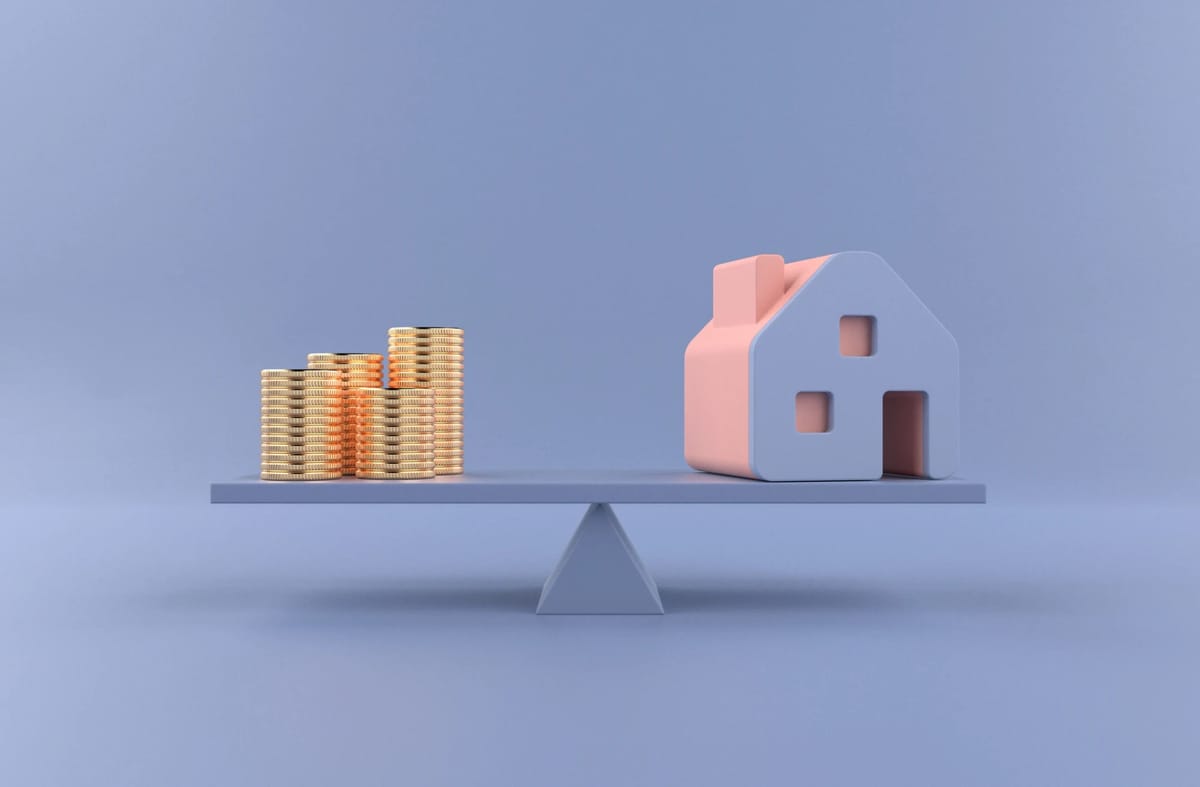 Balance scale with coins and a house