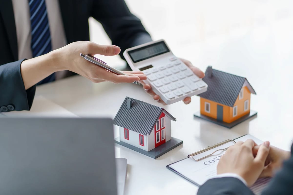 Property advisers comparing two model houses and a calculator