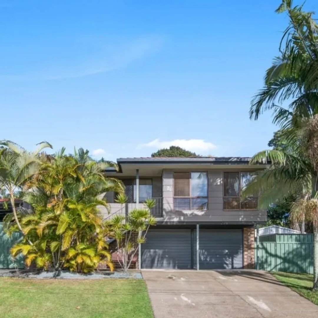 Two-storey investment home with twin garages and palm trees in Brisbane, Queensland