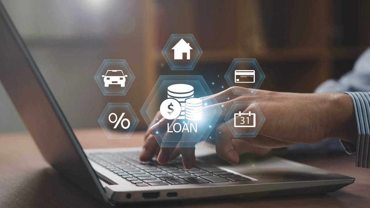 Loan icons around a laptop with hands typing.