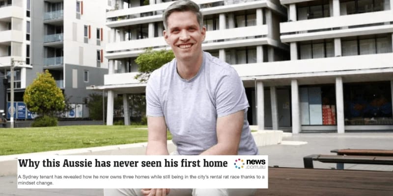 Man sitting outside modern apartment buildings