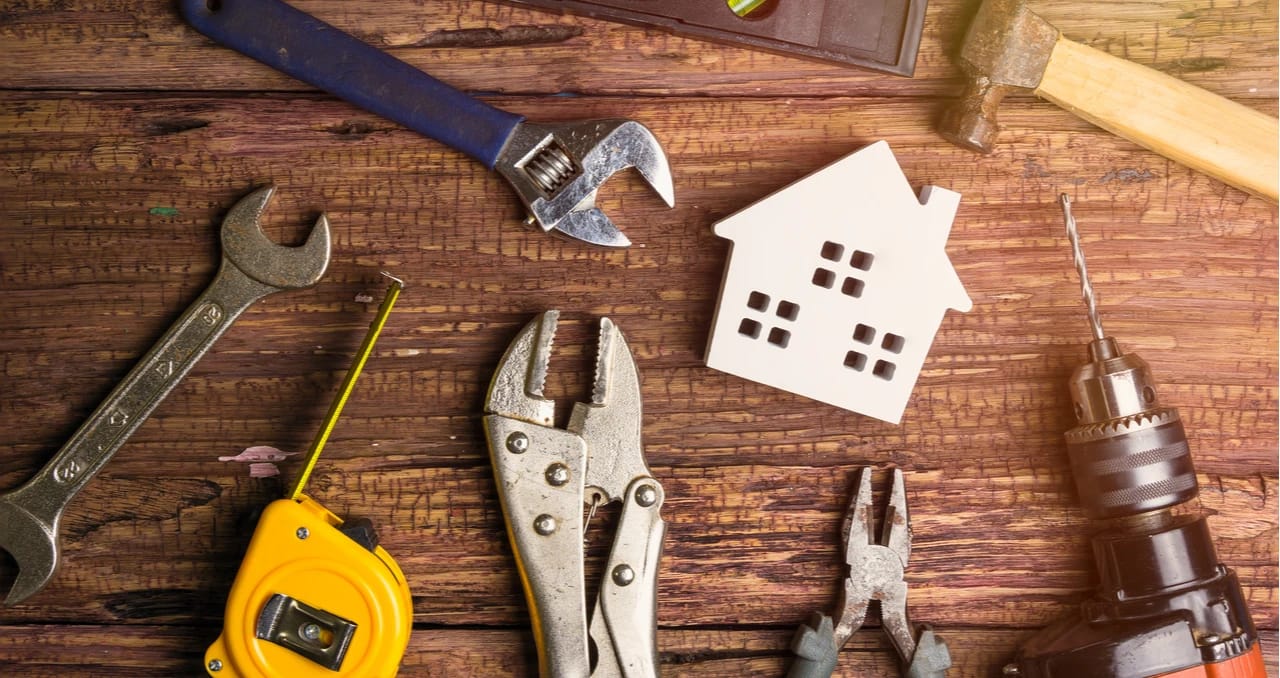 Property maintenance tools surrounding a model house