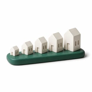 Five white ceramic houses rising in size from left to right.