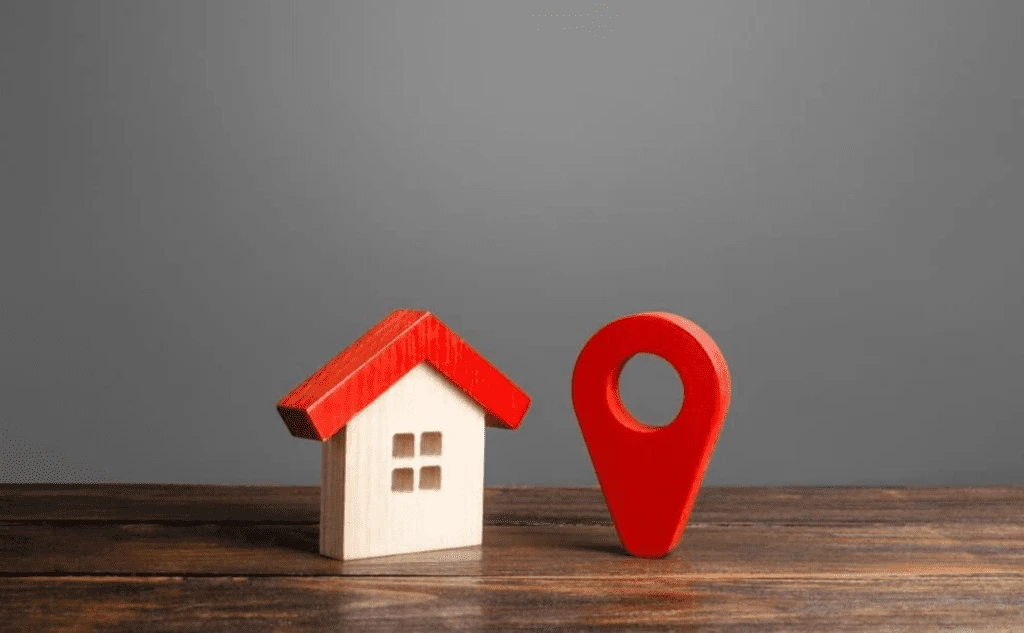Model house and map pin representing property location assessment