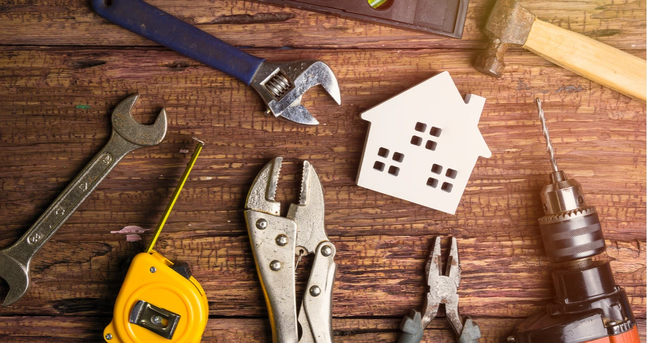 Property maintenance tools surrounding a model house