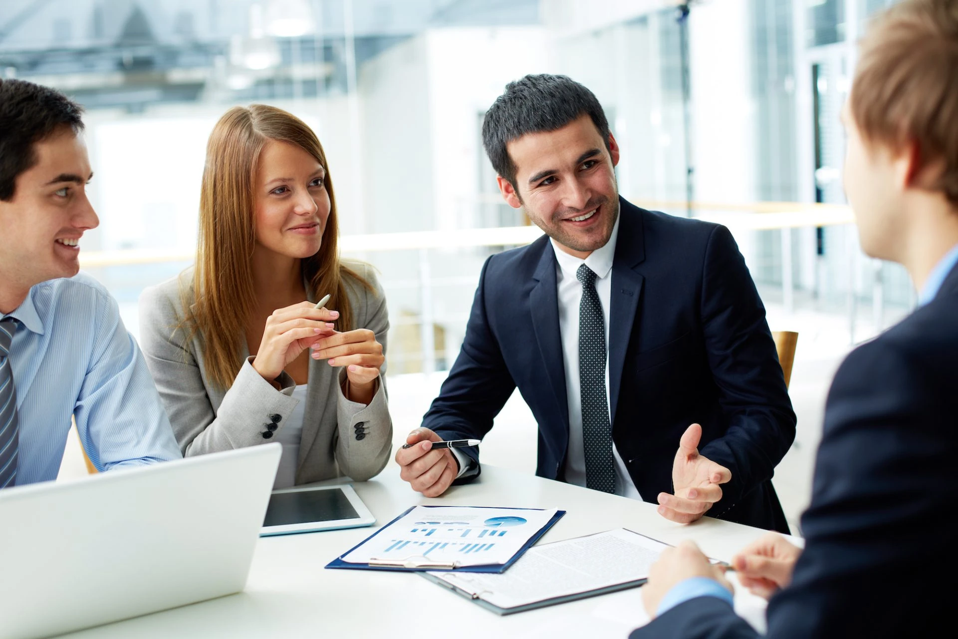 Financial advisers discussing property investment strategy around a meeting table
