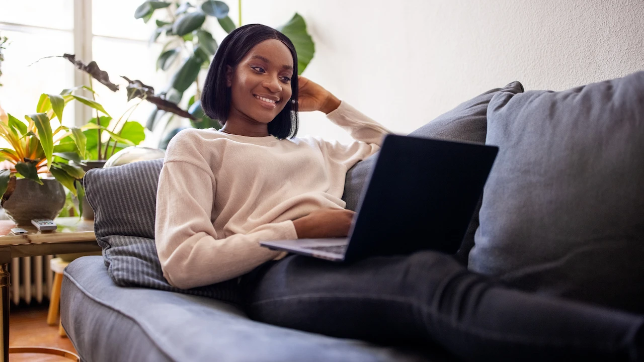 Woman using an online automated property valuation platform on a laptop