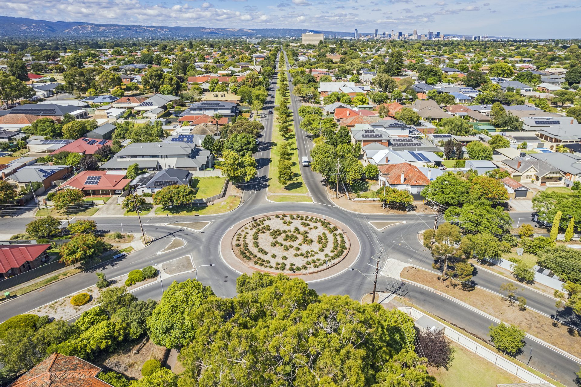 Aerial view of established Adelaide north-eastern suburb with roundabout, hills and CBD in distance Image of iStock 1472869336 1 scaled